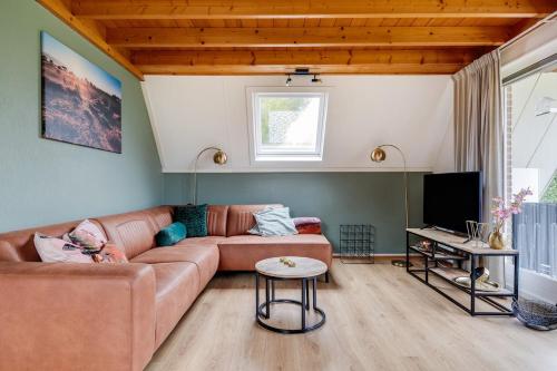 Una televisión o centro de entretenimiento en Gekraagde Roodstaart I Bungalow met Fijne Groene Tuin