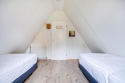 Una cama o camas en una habitación de Gekraagde Roodstaart I Bungalow met Fijne Groene Tuin