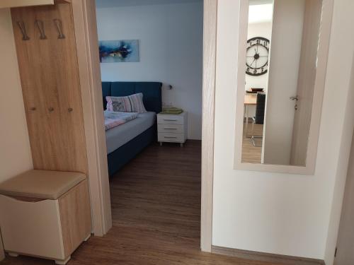 a small bedroom with a bed and a mirror at Ferienhaus Mauthen 206 in Kötschach