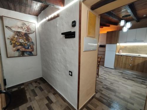 a hallway of a kitchen with a white wall at La Casita de Claudia in Aguatona