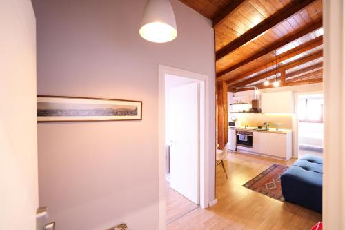 a living room with a blue couch and a kitchen at Tirana Experience, Authentic Stays in the Heart of Old Tirana in Tirana