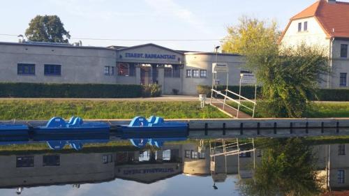 a group of boats sitting in the water in front of a building at Marina Park Eberswalde in Eberswalde