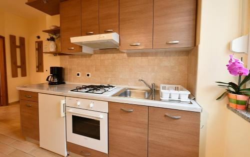 a kitchen with a sink and a stove at Apartments Barbalic Beach in Baška