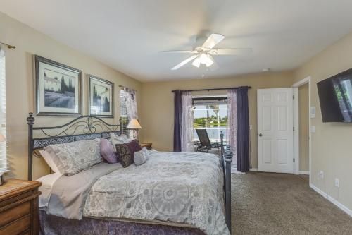 a bedroom with a bed and a ceiling fan at Herons' View Villa in Biggar