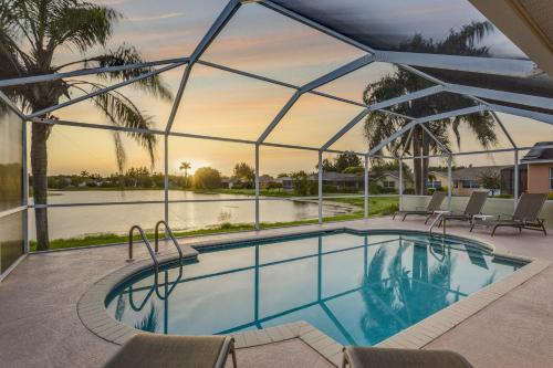 a swimming pool with a view of the water at Herons' View Villa in Biggar