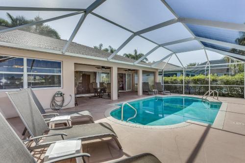 a patio with a swimming pool and chairs at Herons' View Villa in Biggar