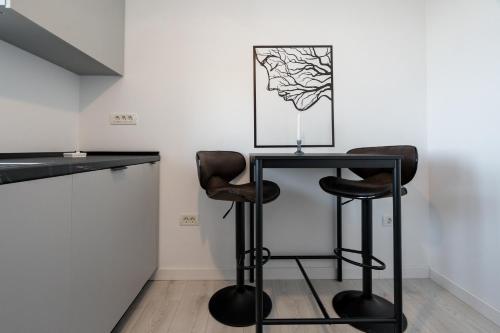 a bar with two stools and a table in a room at AeroPrime - LOFT in Tunari