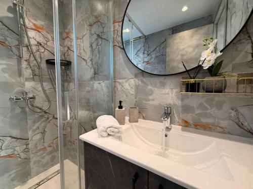 a bathroom with a sink and a mirror at New Luxury Georgia Beach Villa II in Argaka