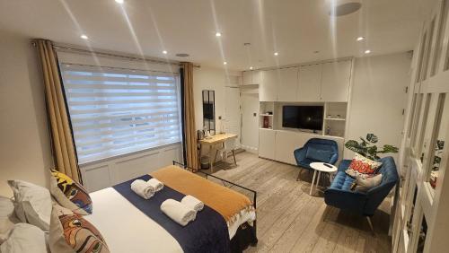 a bedroom with a large bed and a living room at Pop Art Luxury Room Marylebone in London