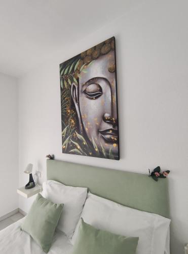 a painting above a bed in a bedroom at Hikari&Sineida Home in Rincón de la Victoria