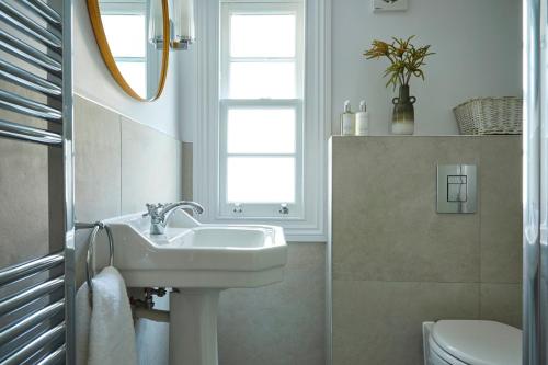 a bathroom with a sink and a toilet at Georgian House Hotel in London