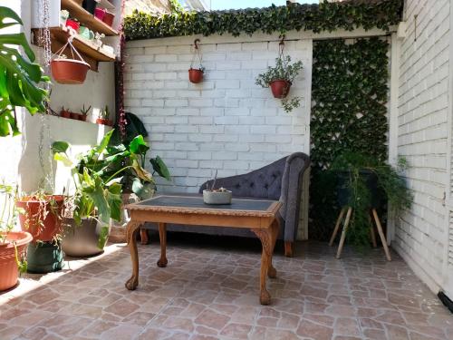 a bench sitting on a patio with potted plants at 2 dormitorios, 2 baños in Santiago