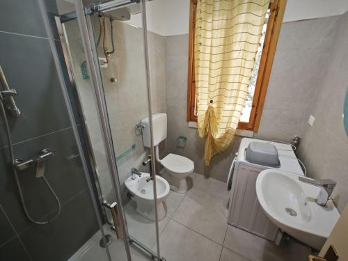 a bathroom with a sink and a toilet and a shower at Cacciatore in Rosolina