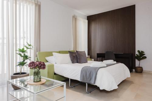 a bedroom with a bed and a glass table at Fl 1 Thelodge - Charming Retreat By Homely in Mellieħa