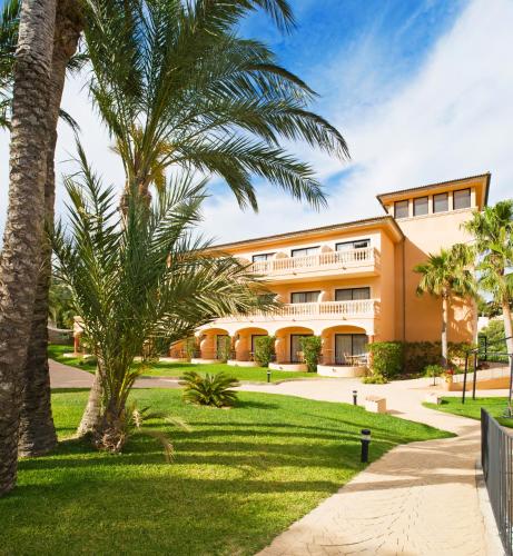 an exterior view of a building with palm trees at Mon Port Hotel & Spa in Port d’Andratx