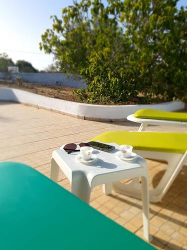 a white table and chairs on a patio at Casa do Campo in Carvoeiro