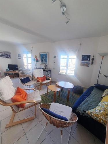 un soggiorno con sedie e un divano di agreable appartement situe en front de mer a Soulac-sur-Mer