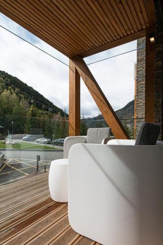 a table and chairs in a room with a large window at Vip Residences Andorra in El Tarter