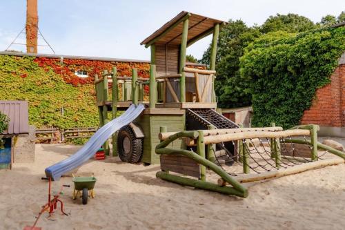 a playground with a slide and a play structure at Inselhaus EG und OG in Staberdorf