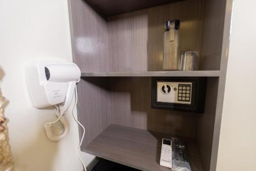 a room with a phone on a wall with a phone at Anahaw Seaside Inn in Bantayan Island