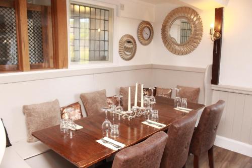 a dining room with a wooden table and chairs at Kings Head Inn in Rye