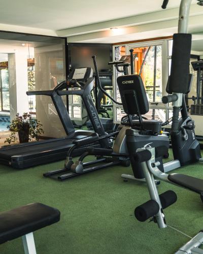 a gym with several treadmills and exercise bikes at Patagonia Plaza Hotel in San Martín de los Andes
