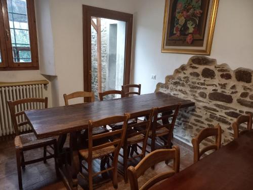 a dining room with a wooden table and chairs at B&B Il Pittore in Borgo San Lorenzo