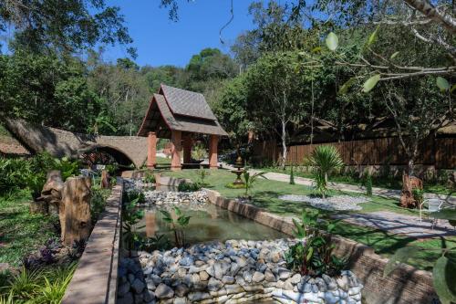 a garden with a pond and a gazebo at iRETREAT Jungle Bliss, Pa Pae in Ban Pa Pae
