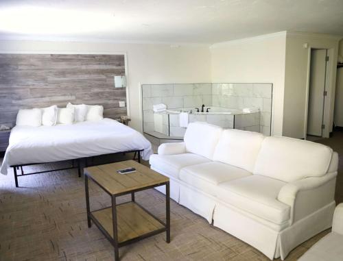 a living room with a couch and a bed at Best Western Branson Inn and Conference Center in Branson