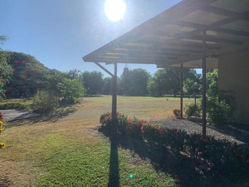 a pavilion in a yard with flowers in a field at Conectar con la naturaleza in Esparza