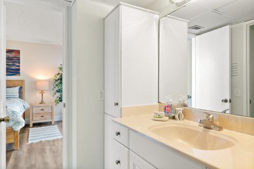a bathroom with a sink and a mirror at Moon Bay C1 Key Largo Sunsets - 2 bedroom Townhouse sleeps 4 in Key Largo