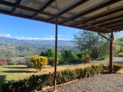 a view from the patio of a house with a pergola at Conectar con la naturaleza in Esparza