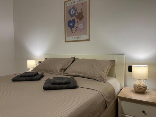 a bedroom with a bed with two pillows on it at Matea Apartment in Čitluk
