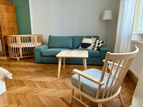 a living room with a couch and a chair and a table at Śląska 33 in Gdynia