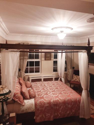 a bedroom with a bed with a canopy at Riverside Lodge in Carlingford