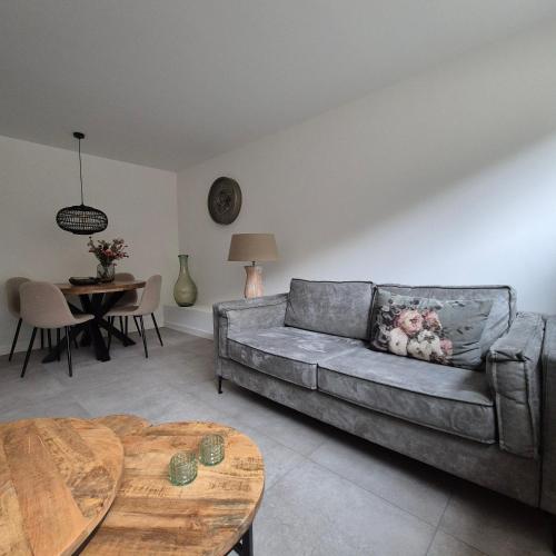 a living room with a couch and a table at Het Klokkenest in Katwijk aan Zee
