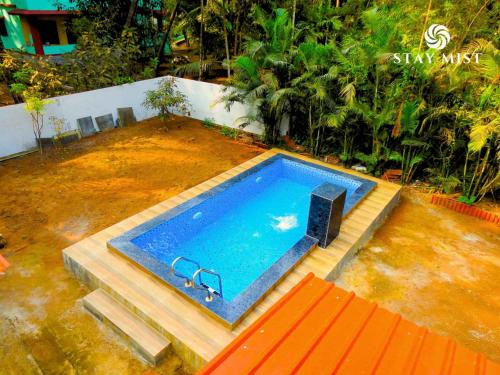 an overhead view of a swimming pool in a yard at Sea Olive Villa - Stay Mist in Nagaon