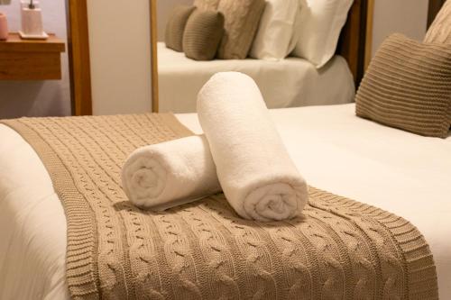 a couple of towels sitting on top of a bed at Pousada K in Pirenópolis