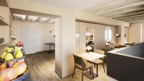a kitchen and living room with a table and chairs at Le Vieux Moulin Weywertz in Butgenbach