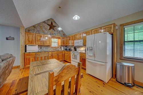 a kitchen with wooden cabinets and a white refrigerator at Copper Valley in Blairsville