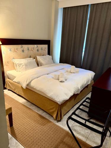 a bedroom with a large bed with white sheets at ESPERIA Drama HOTEL in Drama