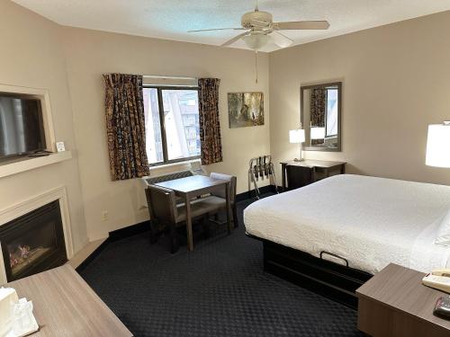 a hotel room with a bed and a desk at Sidney James Mountain Lodge in Gatlinburg