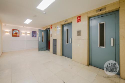 um corredor com portas azuis num edifício em Malasaña exclusiva para 4, ven a San Bernardo 20 E3 em Madrid