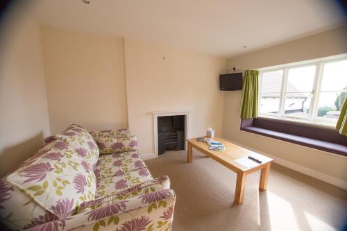 a living room with a couch and a table at Star Inn in Stroud