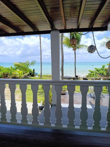 a view of the beach from the balcony of a resort at Aquavit pousada e comedoria in Jacumã