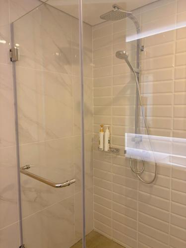 a shower with a glass door in a bathroom at Cassia Rama9 Loft Highrise View Central in Bangkok