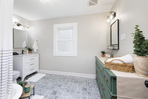a bathroom with a green dresser and a sink at Walk to Highland Square, Sleeps 8 in Akron