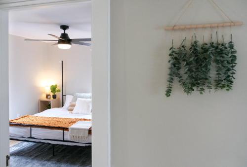 a bedroom with a bed and a plant on the wall at Walk to Highland Square, Sleeps 8 in Akron