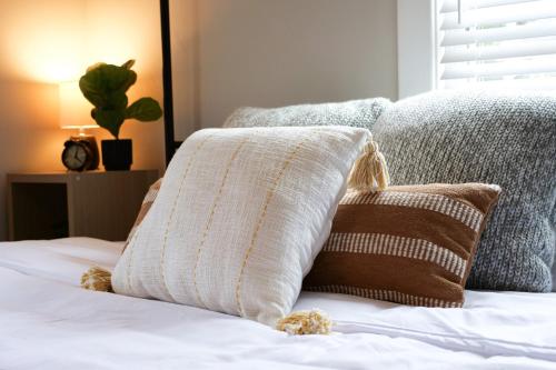a bed with two pillows and a plant on it at Walk to Highland Square, Sleeps 8 in Akron
