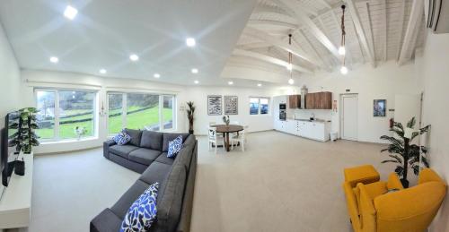 a living room with a couch and a table at Flores Whale Watch House in Faja Grande